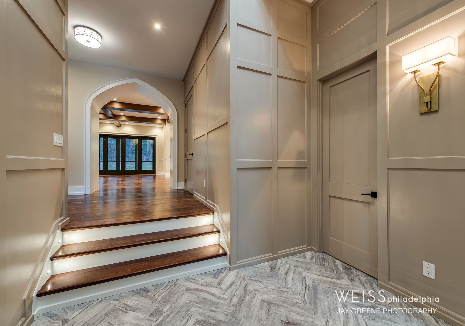best custom homes wayne pa - design home studios - monochrome tan walls and doors - curved archways - hallway
