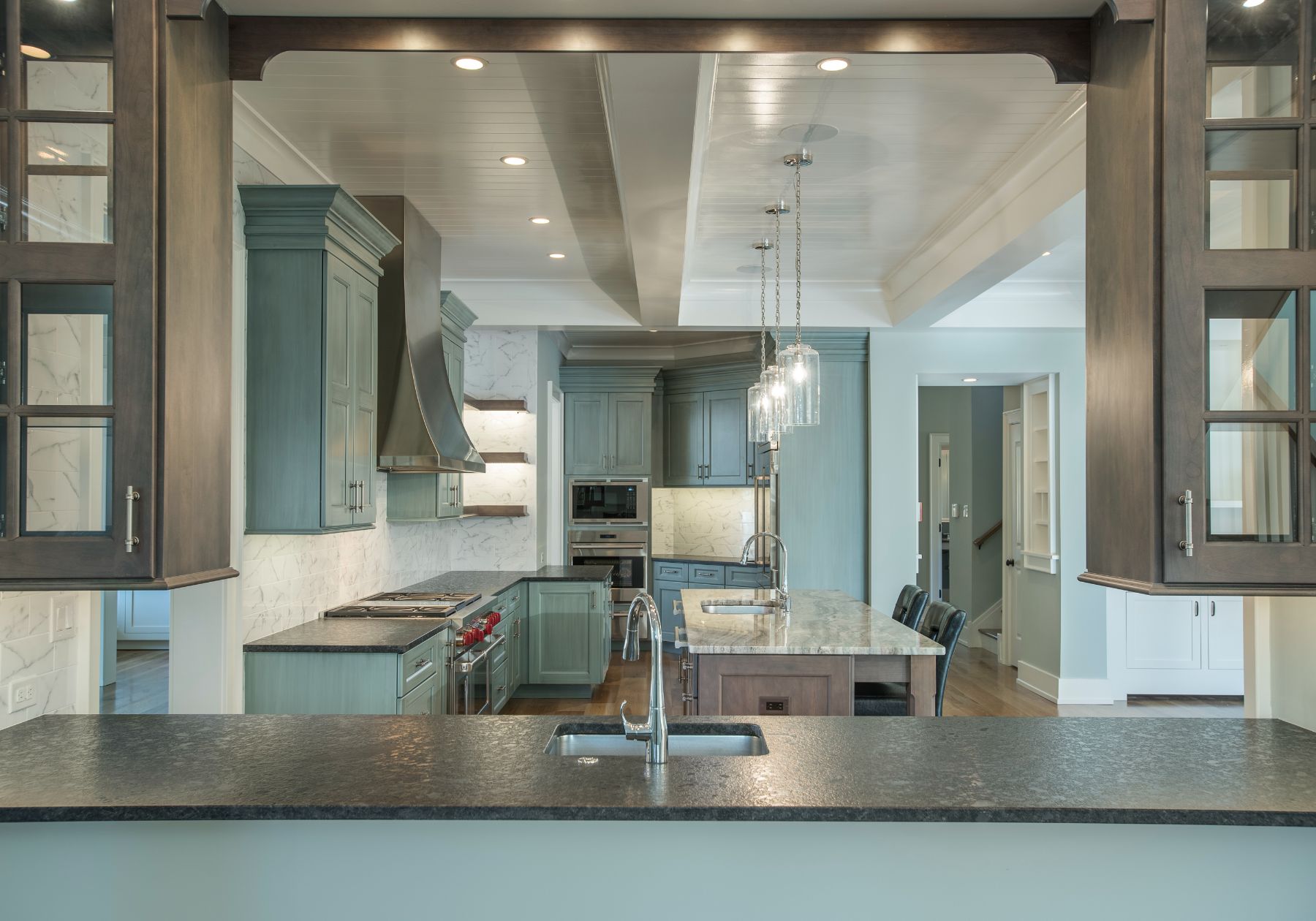 custom kitchen - teal cabinets - stainless steel appliances - dark countertops - design home studios