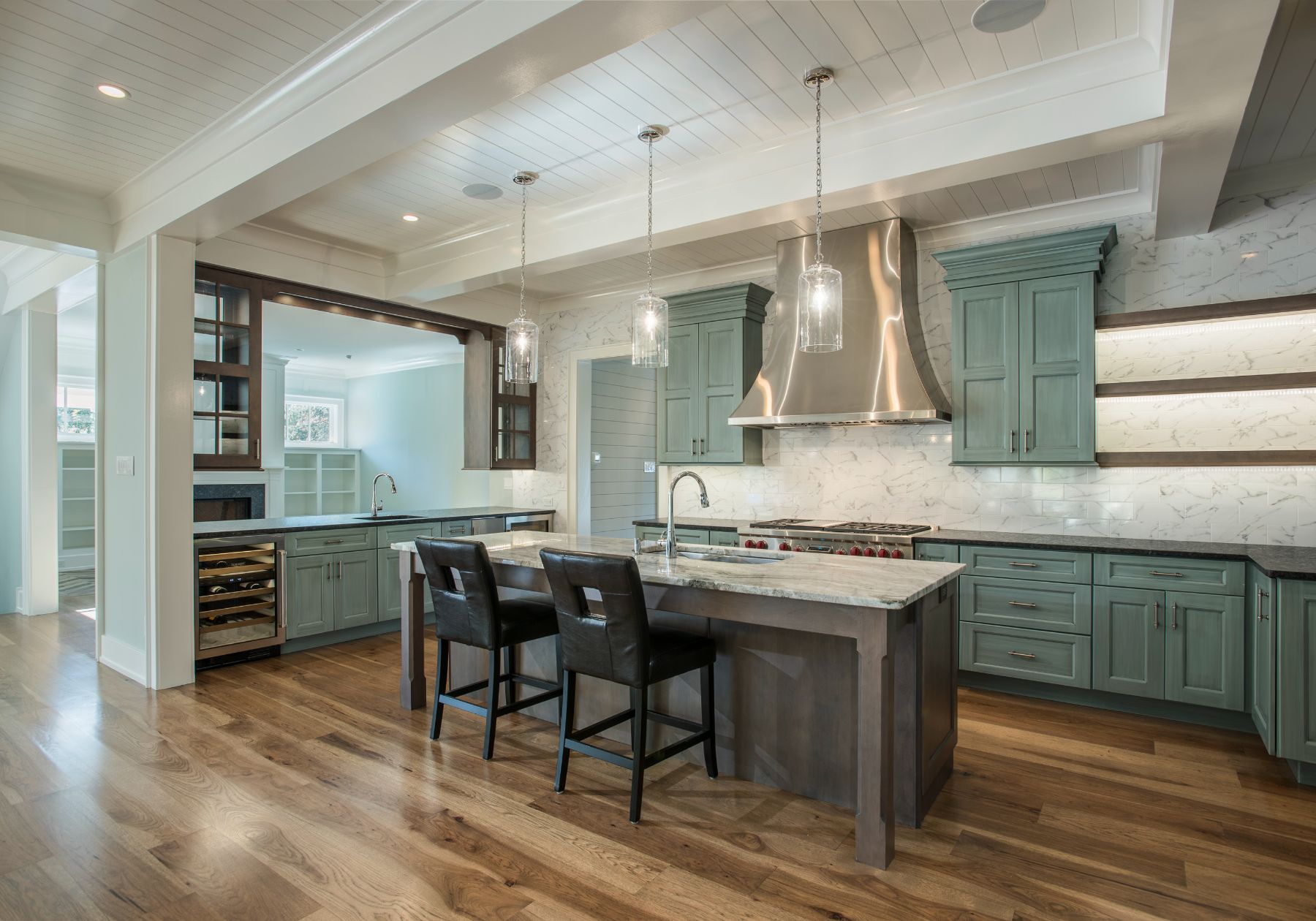 custom kitchen - teal cabinets - stainless steel appliances - dark countertops - design home studios - breakfast bar