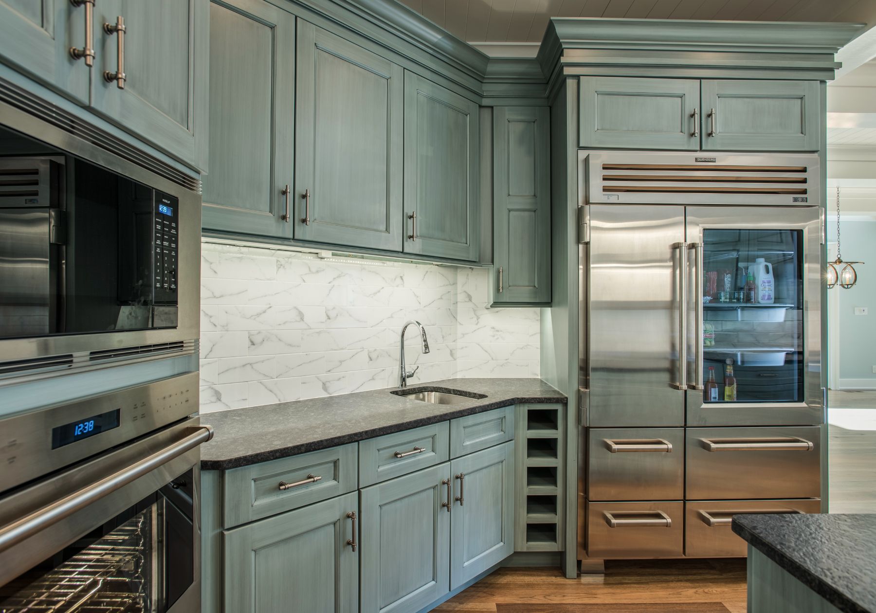 custom kitchen - teal cabinets - stainless steel appliances - dark countertops