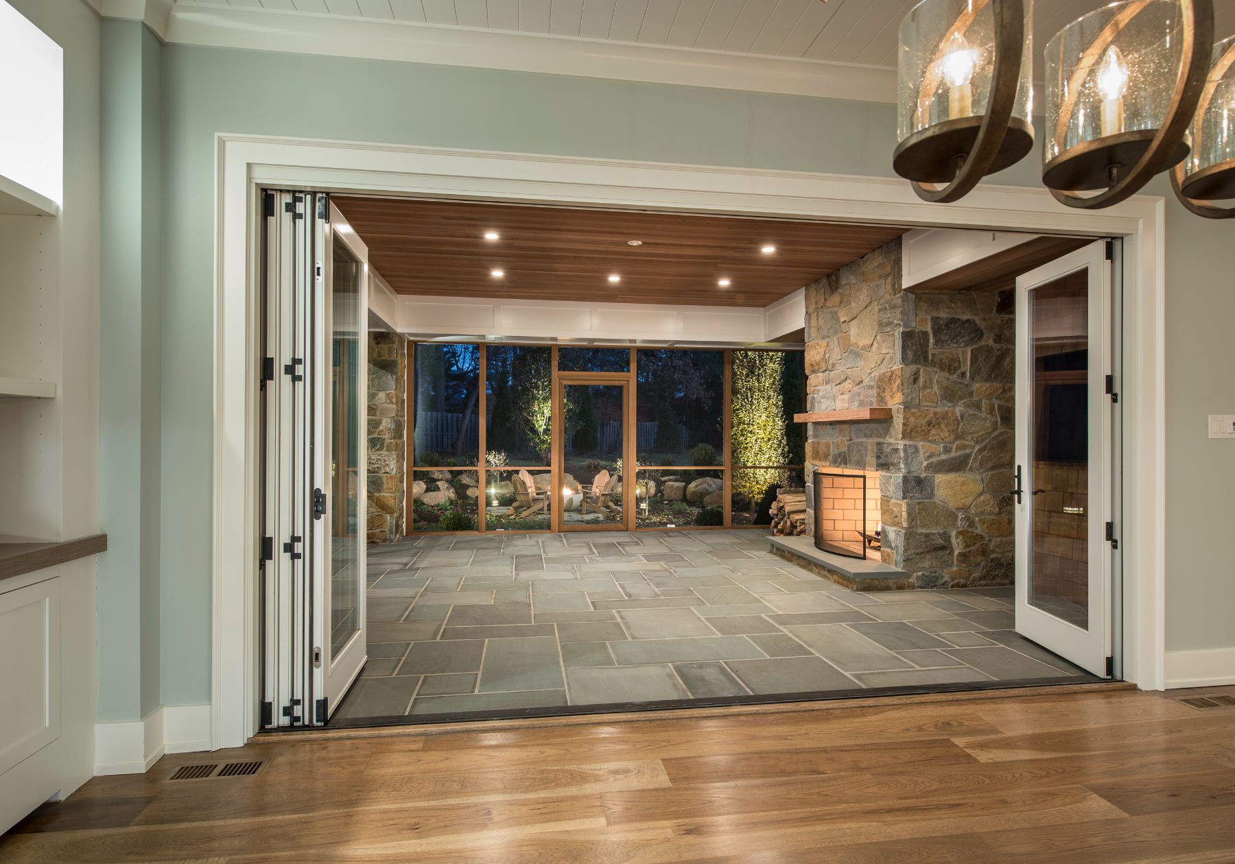 custom home builder Philly - screened in porch - outdoor fireplace - blue walls - wooden ceilings